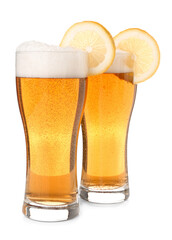 Glasses of fresh light beer with lemon slices on white background