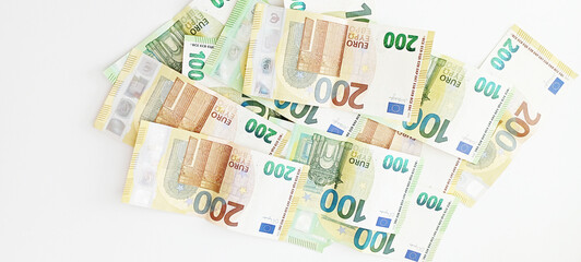 Crypto currency concept - A bitcoin with euro bills, 100 euro and 200 euro banknotes