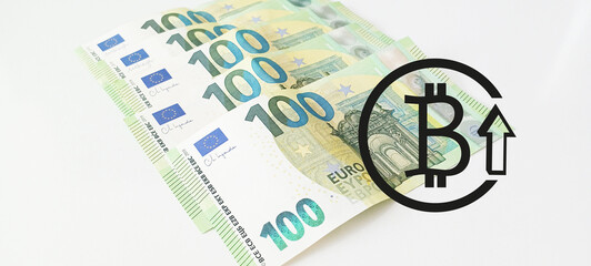 Crypto currency concept - A bitcoin with euro bills, 100 euro and 200 euro banknotes