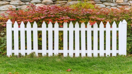 Charming White Picket Fence Surrounded by Autumn Foliage in a Serene Garden