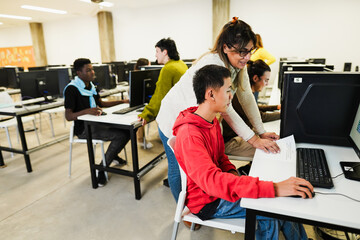 Students using computers softwares at college IT class - Woman teacher working at university - Back...