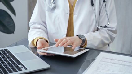 Doctor at work. Medical professional using tablet in clinic office. Medicine and health care concept