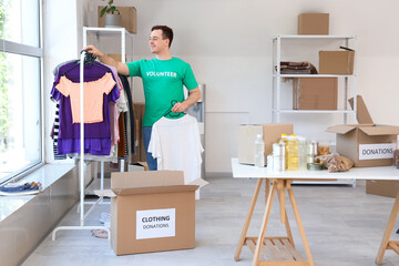 Male volunteer donating clothes in center