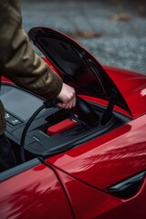 Tiana Enjoys a Cozy Afternoon Charging Her Sleek Red Sports Car in a Tranquil Setting