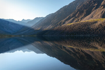 mountains lake reflection sunlight morning