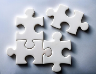 Puzzle pieces carved out in closeup against a white background