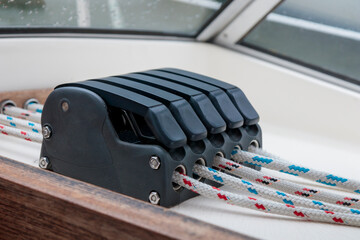 Sailing boat ropes at stoppers. Line jammer. Yachting details.