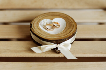 Wooden stand for wedding rings in the shape of a heart