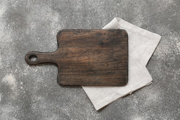 Wooden cutting board on grunge background