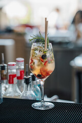  A vibrant and colorful fresh fruit cocktail served in a glass, showcasing a mix of tropical fruits, perfect for a refreshing summer treat by the beach.