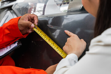 Insurance agent man measuring car damage for evaluation claiming