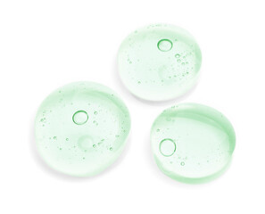 Drops of green cosmetic oil on white background