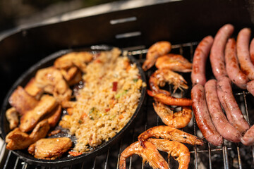 A delicious BBQ feast with chicken fried rice shrimp and sausages