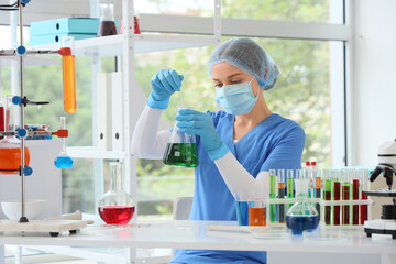 Female chemist with flask in laboratory