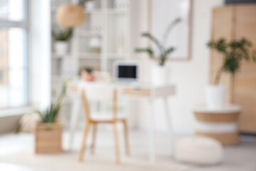 Blurred view of light office with workplace, shelf unit and plants
