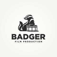 Obraz premium silhouette honey badger sitting on a film reel icon logo vector illustration design. simple modern film production logo concept