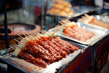 Traditional Thai style grilled meat stick. Street food market.