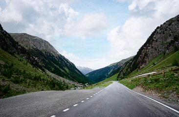Asphalt road in Alps mountains. Road trip concept. Beautiful landscape.