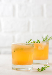 Pear lemonade with rosemary, thyme and ice in a glass. Healthy drink, sugar and alcohol free. Vertical orientation.