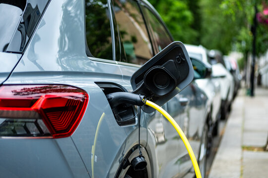 An electric car plugged in on charge on a residential street in central London