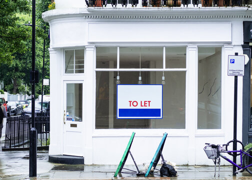 Vacant empty shop with To Let sign in shop window