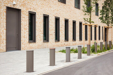 Bollards on Footpath in Front of Modern Building in Germany. Metal Barrier Pillars. Automatic Lifting Bollards Restricting the Driveway of Vehicles.