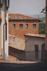 Facade of a old buildings. ancient city with old houses on street, Barolo, Italy