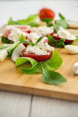 tomato wedges with cottage cheese filling and garlic, spicy appetizer