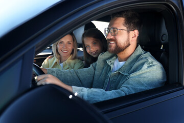 Happy family enjoying trip together by car, view from outside