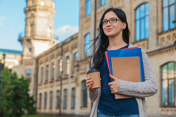 Female college student woman in eyeglasses casual clothes holding books notebooks standing with to...