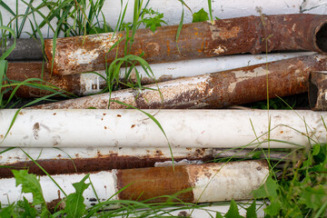 A pile of old rusty metal pipes