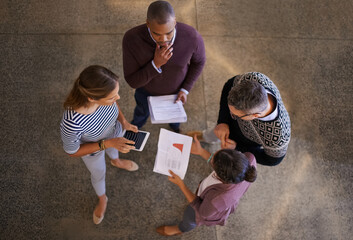 Naklejka premium Teamwork, people and top view of meeting in office, discussion and employees together in creative workplace with statistics. Report, professional and project for growth, worker and collaboration