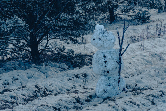 A lonely snowman in the dark, dark, very cool blue light, portrait of a snowman, creative phote, cool light, blue, horror