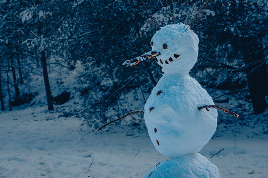 A lonely snowman in the dark, dark, very cool blue light, portrait of a snowman, creative phote, cool light, blue, horror