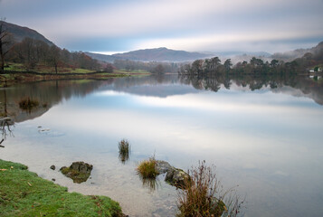 Peaceful morning on the lake of Rydal water in the mountains of the Lake District National Park