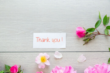 light wooden background with bright pink roses