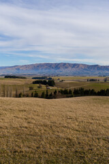 Fototapeta premium Meadow field view with the mountain in the background.