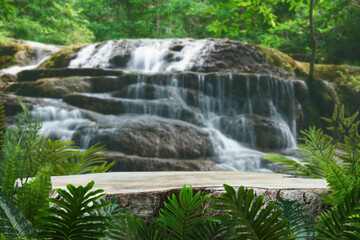 Wood table top podium in outdoor waterfall green tropical forest nature background.Organic natural water product present placement pedestal counter display, spring summer jungle paradise concept.