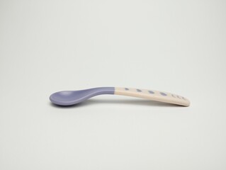 Baby Purple plastic spoon isolated on white background.
