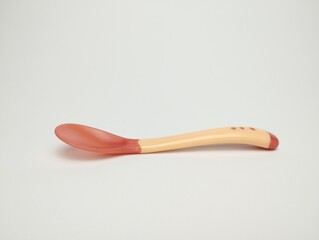Baby Purple plastic spoon isolated on white background.