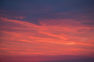 Clouds of purple, pink and orange colours on the sky. Colorful sky during beautiful summer sunset