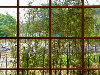 a wooden window with a view of the garden