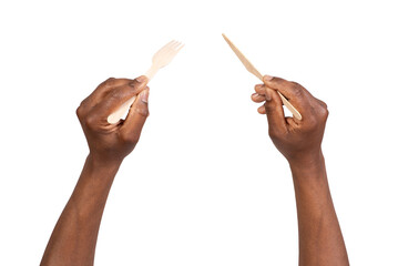 Man holding disposable wooden fork and knife, isolated on white or transparent background