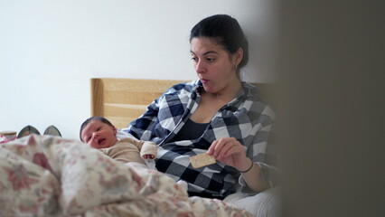 Mother with newborn baby resting on bed, looking tired and contemplative, highlighting the...