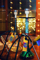 Shisha bar lounge in smoke with spotlights in the night dark blue colors