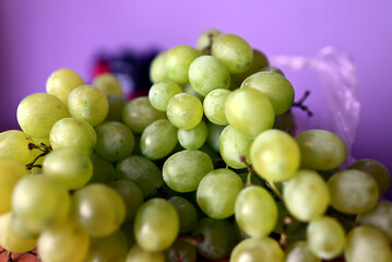 fresh grapes in a basket on a wooden table