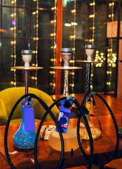 Shisha bar lounge in smoke with spotlights in the night dark blue colors