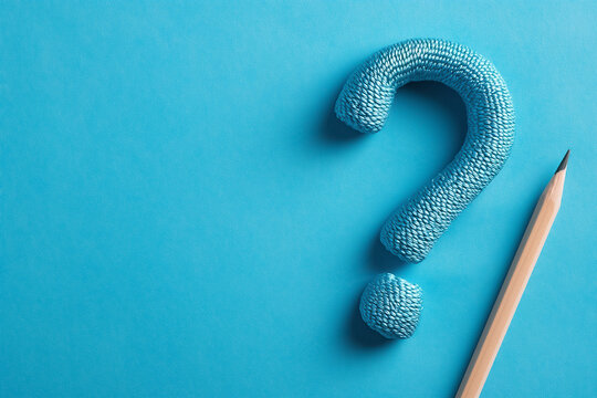 Artwork creatively illustrates a Question Mark using colorful pencils set against a vibrant blue chalkboard background