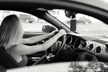 Young woman driver hands close up hold steering wheel car.