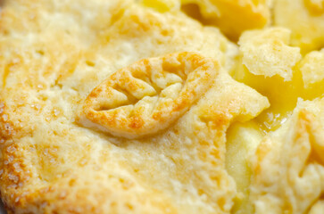A apple pie with a leaf design on top